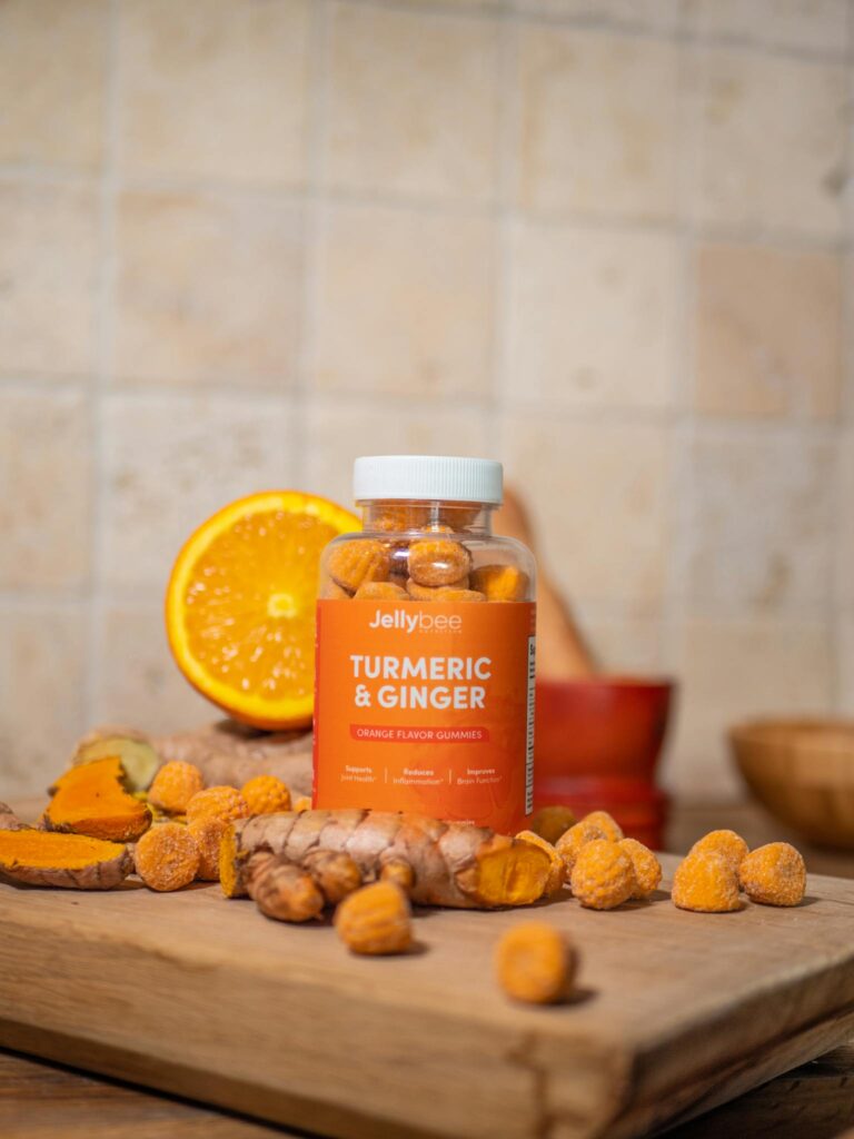 Vibrant product shot of turmeric and ginger gummies with fresh ingredients.